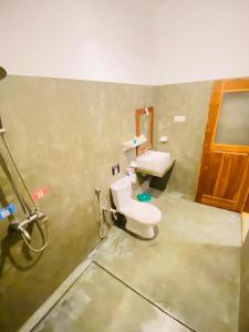 a bathroom with a toilet and a sink at Lavender mirissa in Mirissa
