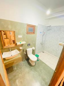a bathroom with a toilet and a sink and a shower at Lavender mirissa in Mirissa