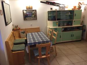 a kitchen with a table and chairs and a cabinet at Romantic Forest House Tršće in Tršće