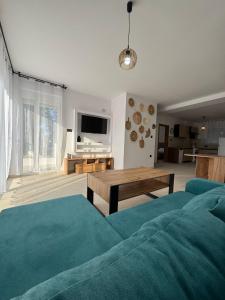 a living room with a couch and a table at Villa & Apartament Armonia 3 Gaja Flora Gavalochori - Vamos KRETA in Vamos