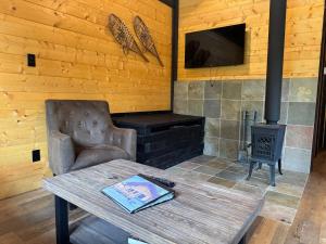 a living room with a table and a stove at Mountaineer Creekside Cabin - Private Hot Tub in Golden