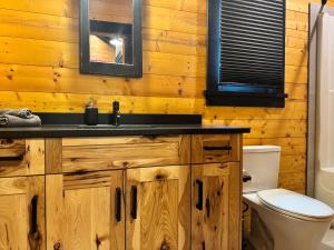 a bathroom with a sink and a toilet at Explorer Creekside Cabin - Private Hot Tub in Golden +41 photos
