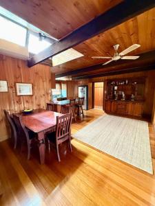 a dining room with a wooden table and chairs at The Moona Cabin - Barwon Heads in Barwon Heads