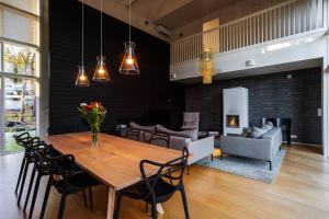 a dining room with a wooden table and chairs at Stay North - Peikkola in Kirkkonummi