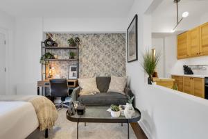 a bedroom with a bed and a couch and a table at The Sherbrooke Suite 101 in Montreal