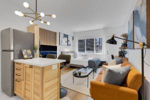 a kitchen and living room with a couch and a table at The Sherbrooke Suite 99 in Montreal