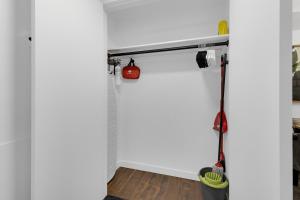 a room with a white wall with a mop at The Sherbrooke Suite 101 in Montreal