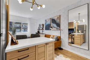 a kitchen with a white counter and a living room at The Sherbrooke Suite 99 in Montreal +19 photos