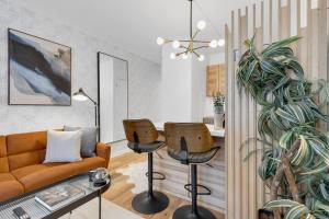 a living room with a couch and two chairs at The Sherbrooke Suite 99 in Montreal
