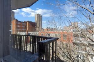 a balcony with a view of a city at The Speakeasy Suite 502 With Parking in Montreal