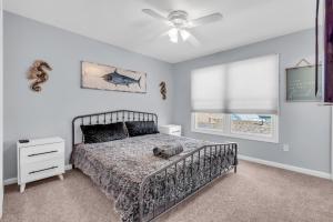 a bedroom with a bed and a ceiling fan at Seaside Park Beach Home 3BR w Deck Peloton Parking 6 Beach Passes in Seaside Park