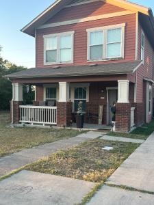 a red house with a porch and a driveway at Southside 3bed 2Ba Spacious Comfy Home in Fort Worth