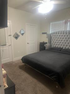 a bedroom with a large bed with a large headboard at Southside 3bed 2Ba Spacious Comfy Home in Fort Worth +23 photos