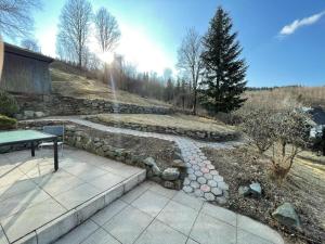 a garden with a bench and a stone path at Dottie's Place in Winterberg