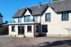 a large white house with a lot of windows at 3 Bed House - Sea Views Balcony Parking Pets in Innellan