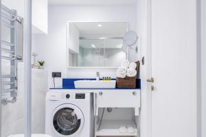 un bagno con lavatrice e lavandino di Elite Class Sea View Aparthotel In Orbi City Batumi a Batumi 1 altra foto