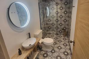 a bathroom with a toilet and a sink and a mirror at 3 Bed House - Sea Views Balcony Parking Pets in Innellan +13 photos