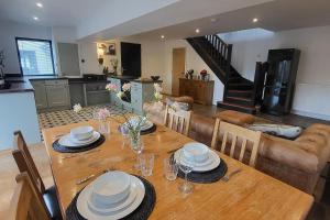 a dining room table with plates and dishes on it at 3 Bed House - Sea Views Balcony Parking Pets in Innellan