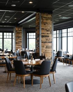 a dining room with wooden tables and chairs at The Geneva Inn in Lake Geneva