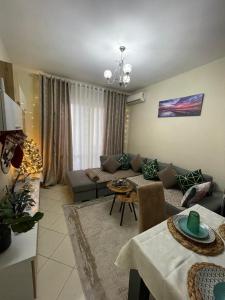 un soggiorno con un divano e un tavolo di The Guest Apartment 2025 a Fier