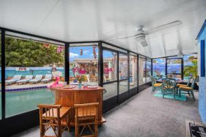 a restaurant with a pool and a table and chairs at The Leon Lane Oasis w Pool Fire Pit Steps to the Beach in Cape Canaveral
