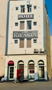 a hotel with a sign on the side of a building at The Rivanta Hotel Near Airport Road Mohali Zirakpur Chandigarh in Zirakpur