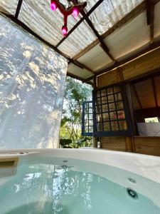 a hot tub in a house with a roof at Floresta das Evas in Petrópolis