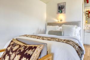 a bedroom with two beds with white walls at O Miminho, a Home in Madeira in São Jorge +22 photos