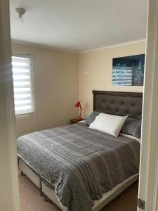 Un dormitorio con una cama y una ventana en habitacion doble con baño en suite, en Valdivia