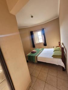 Postel nebo postele na pokoji v ubytování Hotel Avenida Paraísopolis MG