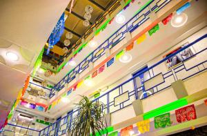 a room with colorful lights on the ceilings and a plant at Hotel Muy Cdmx, Love Hotel in Mexico City +94 photos