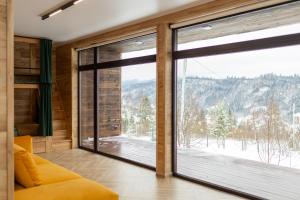 a room with a large window with a mountain view at Яблуневий схил in Tukhlya