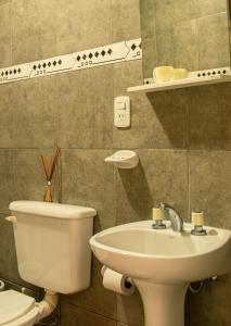 a bathroom with a toilet and a sink at LOS GURISES Villa Elisa in Villa Elisa