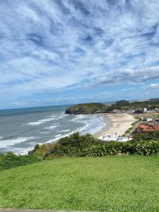 a view of a beach and the ocean at Casa das Oliveiras in Torres