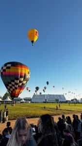 a crowd of people watching hot air balloons at Casa das Oliveiras in Torres