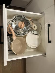 a cupboard filled with lots of kitchen utensils at Cedar & Sage Suite the Cozy Retreat with Full Kitchen in Victoria +19 photos