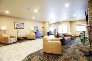 a lobby with couches and chairs in a room at Cobblestone Hotel & Suites - Devils Lake in Devils Lake