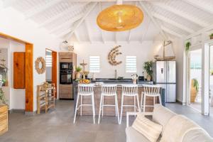 a kitchen with a table and chairs in a room at Villa Bohème in Terre-de-Haut