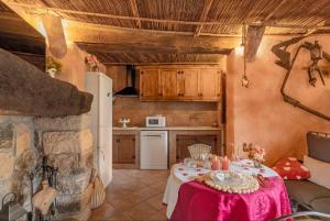 a kitchen with a table with a pink table cloth at La Cova de Can Pavet in Pontons
