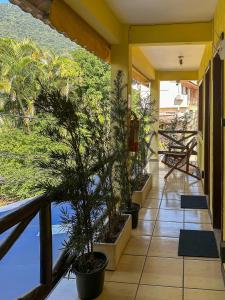 a balcony with potted plants on the side of a building at Buena Onda Suites in Abraão