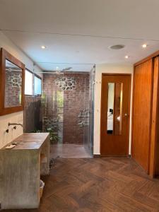 a bathroom with a shower and a glass door at Mocca Hotels in Tepoztlán