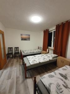 a room with three beds and a window at MRS in Hürth