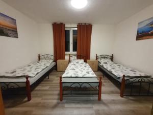 a room with three beds and a window at MRS in Hürth