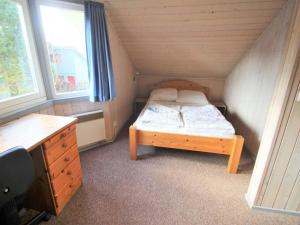 a small bedroom with a bed and a desk at exklusives skandinavisches Ferienhaus in Granzow
