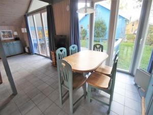 a dining room with a wooden table and chairs at exklusives skandinavisches Ferienhaus in Granzow