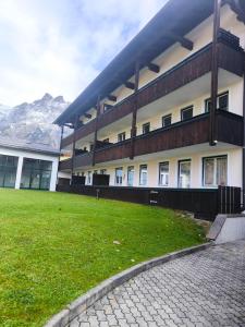 a building with a green lawn in front of it at Alpenperle in Sankt Johann im Pongau