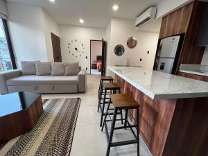 a kitchen and living room with a couch and a counter at Place in the Romantic Zone with a Rooftop 301 in Puerto Vallarta