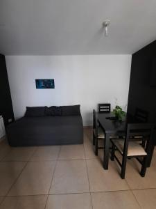 a living room with a couch and a table at Moderno y funcional Dpto cerca del casco histórico de Salta in Salta +6 photos