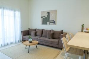 a living room with a couch and a table at Villa Artemis 3 - Etheras Properties in Diakofti