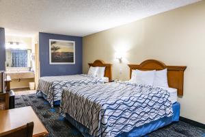 a hotel room with two beds and a table at Boerne Inn and Suites in Boerne +46 photos